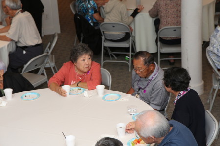 Guests talk amongst friends and the documentary's interviewees, sponsors, and staff over refreshments.