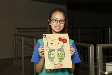 A Scout shows off her creation. Photo: Russell Kitagawa.