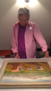 My grandmother looking at a painting in which she is depicted.