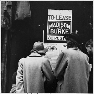 Saturday afternoon shoppers in San Francisco's Chinatown read a Civilian Exclusion Order in this 1942 photograph. National Records and Archives Administration. Photograph by Dorothea Lange.
