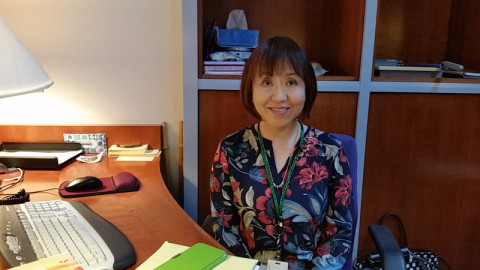 Kyoko Ogawa volunteering at the front desk of the Hirasaki National Resource Center.