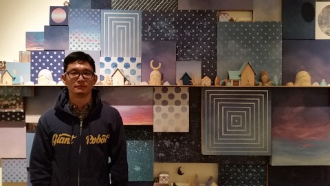 Yoskay Yamamoto in front of his artwork, Wish You Were Here.
