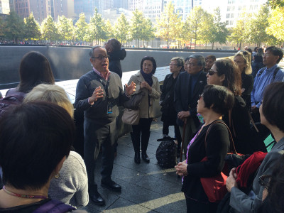JANM board members listen as Clifford Chanin, Vice President for Education and Public Programs at the National September 11 Memorial and Museum, points out features of the outdoor memorial. Photo by Nicole Miyahara.