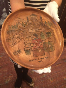 A carved wood plate by Henry Sugimoto, now part of the museum's permanent collection. Photo by Nicole Miyahara.