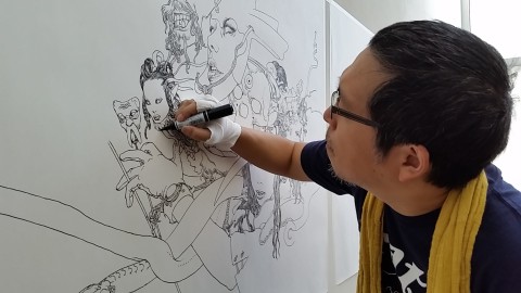 Katsuya Terada at work in the JANM galleries. Photo by Carol Cheh.