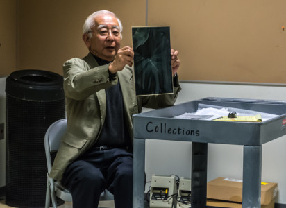 Frank Sata shows us his own personal favorite photograph by his father, J.T. Sata. Photo by Ben Furuta.