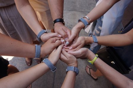 Six members of the 2015 Nisei Week Court join hands with Terry Hara, past president of the Nisei Week Foundation, and his wife Gayle. The matching watches were a gift to the court from the couple.
