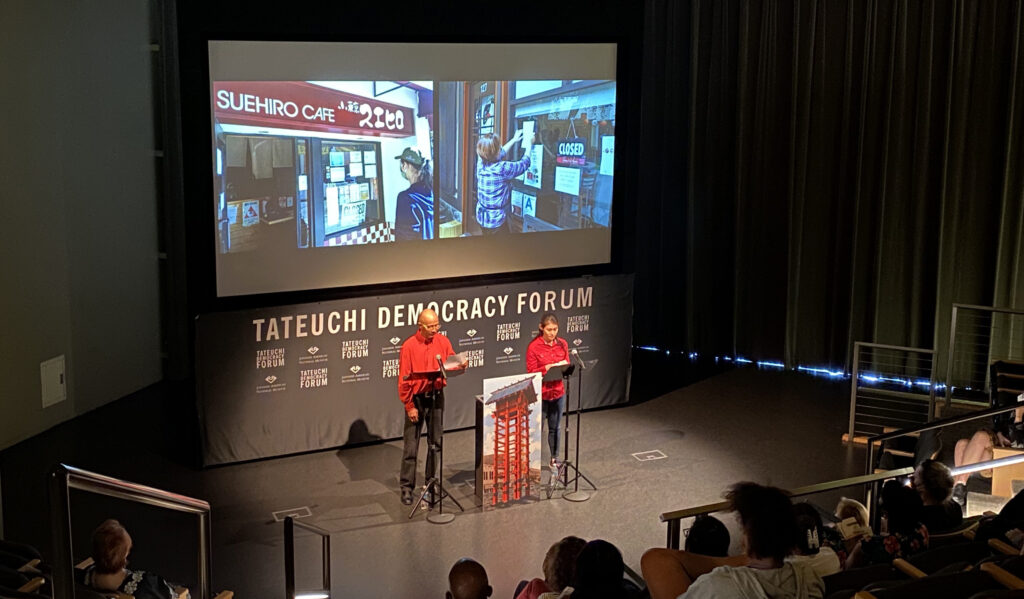 Dan Kwong and Junko Goda reading on stage at the Takeuchi Democracy Forum